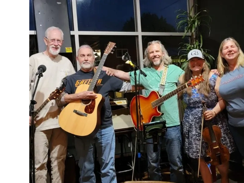 Band group photo with five musicians and guitars